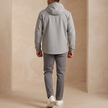 Side view showing the puffer silhouette and zip hip pocket