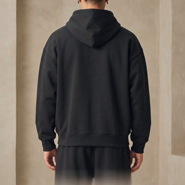Three-quarter view of heavyweight men's hoodie showing overall silhouette