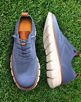 Men's lace-up boots worn, showing rounded toe and low-cut profile