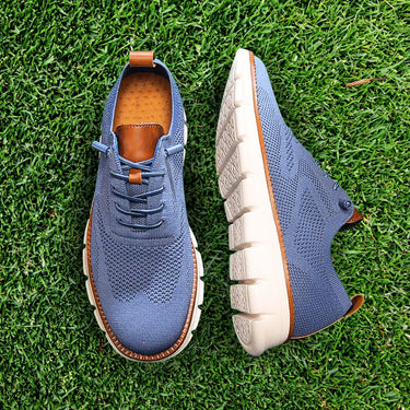 Men's lace-up boots worn, showing rounded toe and low-cut profile