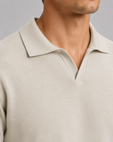 Side view of men's fine-knit polo showing ribbed hem and regular fit