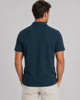 Side profile of men's knitted polo shirt showing tailored silhouette