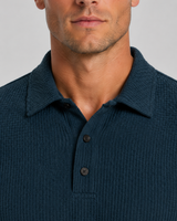 Close-up of textured knit fabric surface and polo collar detail