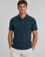 Front view of men's textured knit polo shirt with structured collar and button placket