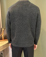 Three-quarter view of a men's ribbed knitted polo shirt worn casually