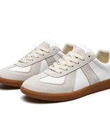 Close-up of contrast stitching across the toe and side panels of the sneaker