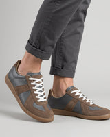 Flat lay of both sneakers showing the panelled upper and flat rubber outsole