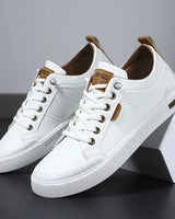 Men's low-top lace-up trainer with panelled upper and rounded toe, front view