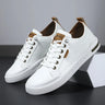 Men's low-top lace-up trainer with panelled upper and rounded toe, front view