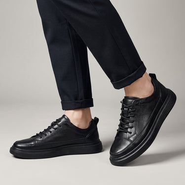 Men's low-top lace-up boots with tonal stitched panels and ridged outsole, front view