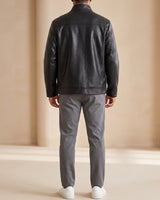 Side view showing the hip length and relaxed silhouette of the leather jacket