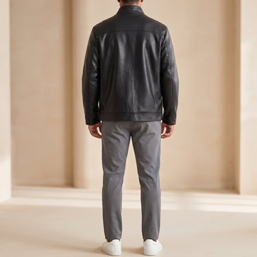 Side view showing the hip length and relaxed silhouette of the leather jacket