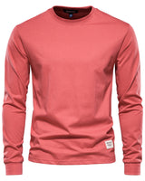 Man wearing a long sleeve polo shirt layered under a casual jacket