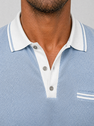 Close-up of contrast collar trim and button placket detail on polo shirt