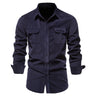 Close-up of buttoned flap chest pockets on men's woven shirt