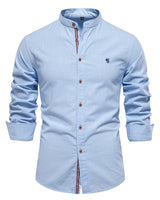 Detail shot of the button closure on a men's mandarin collar shirt