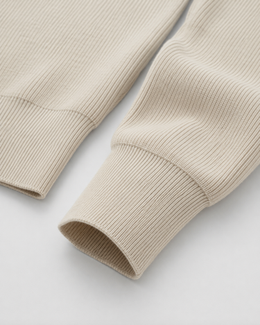 Flat lay of men's zip up knit cardigan on neutral background