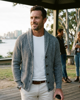 Detail of ribbed hem and button fastening on men's cardigan