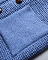 Close-up of button fastening row on men's cashmere cardigan