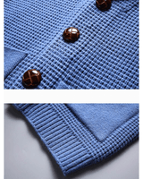 Detail shot of ribbed trim on pocket and hem of cashmere cardigan