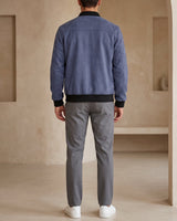 Men's suede bomber jacket showing ribbed cuffs and zip fastening detail