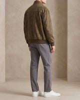 Close-up of patchwork panelling detail on chest and sleeves of the bomber jacket