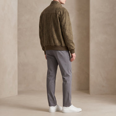 Close-up of patchwork panelling detail on chest and sleeves of the bomber jacket