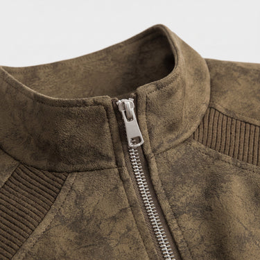 Side view of the short faux leather bomber jacket showing ribbed hem and cuffs