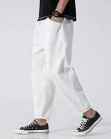 Back view of the cropped tapered trousers showing the clean hem and leg line