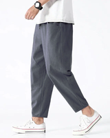 Front view of men's cropped tapered trousers with drawstring waistband