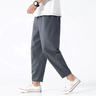 Front view of men's cropped tapered trousers with drawstring waistband