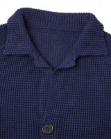 Three-quarter view of men's waffle-knit cardigan with stand collar and buttons