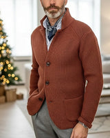 Men's cardigan worn buttoned up with stand collar visible