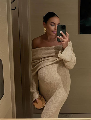Back view of the long-sleeve off-shoulder maternity dress in apricot