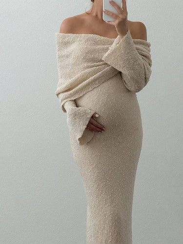 Detail shot of the hem and skirt drape of the off-shoulder maternity dress
