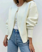 Open front cardigan with pearl trim along neckline and front edge, worn open