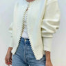 Open front cardigan with pearl trim along neckline and front edge, worn open