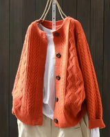 Back view of oversized cable knit cardigan showing full length and texture