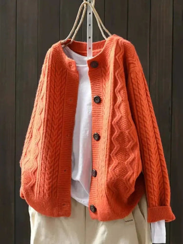 Back view of oversized cable knit cardigan showing full length and texture