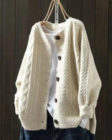 Front view of oversized cable knit cardigan with button-down front and ribbed hem