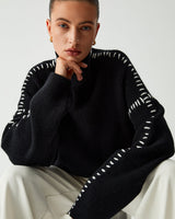 Model wearing the mock neck knit jumper with straight-leg trousers