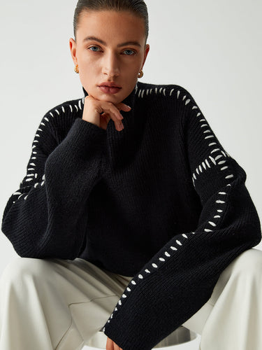 Model wearing the mock neck knit jumper with straight-leg trousers