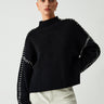 Front view of an oversized knit jumper with mock neck and contrast-stitch seams