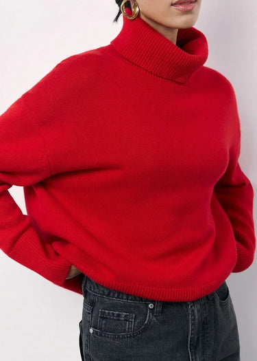 Red oversized sweater showing dropped-shoulder cut and hip-length hem