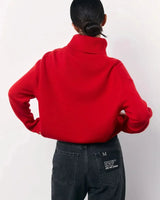 Close-up of the roll neck collar detail on the red sweater