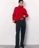 Side view of the oversized turtleneck sweater showing relaxed silhouette