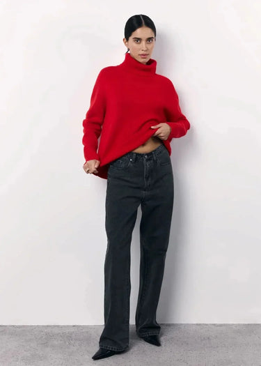 Side view of the oversized turtleneck sweater showing relaxed silhouette