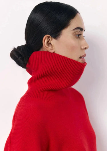 Detail shot of the knitted fabric texture on the red sweater