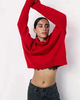 Full-length view of the red turtleneck sweater styled with trousers