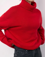 Red oversized roll neck sweater shown from a three-quarter angle